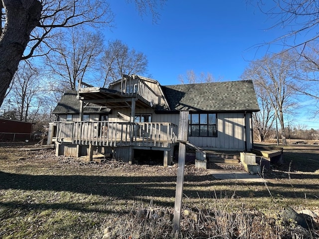 rear view of property with a yard and a deck