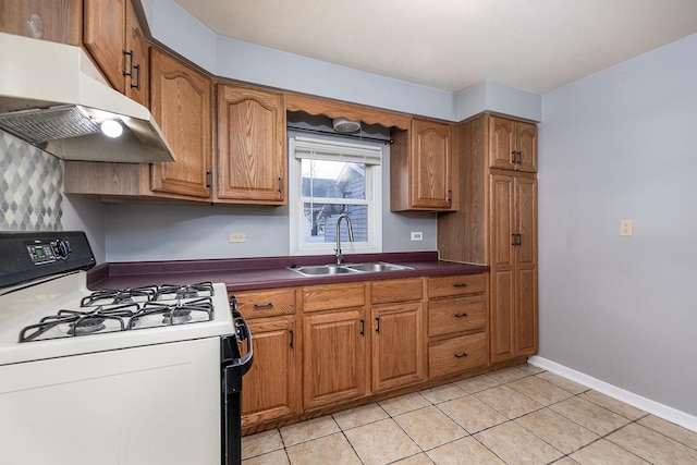 kitchen with sink, light tile patterned floors, and white range with gas stovetop