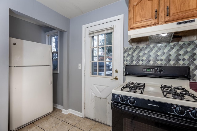 kitchen featuring decorative backsplash, light tile patterned floors, white appliances, and plenty of natural light