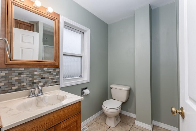 bathroom with tile patterned flooring, decorative backsplash, toilet, and vanity