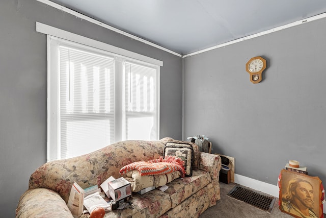 sitting room featuring carpet and ornamental molding