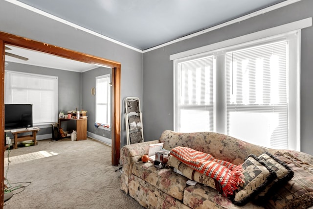 living room featuring light colored carpet, a wealth of natural light, and ornamental molding