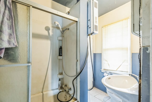 bathroom featuring tile patterned flooring, sink, and bathing tub / shower combination