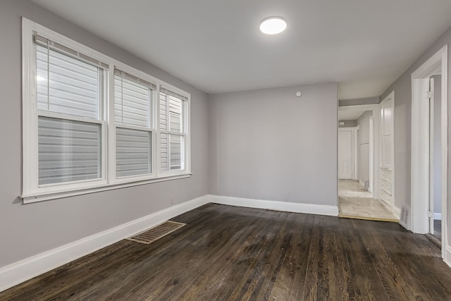 empty room featuring dark hardwood / wood-style flooring