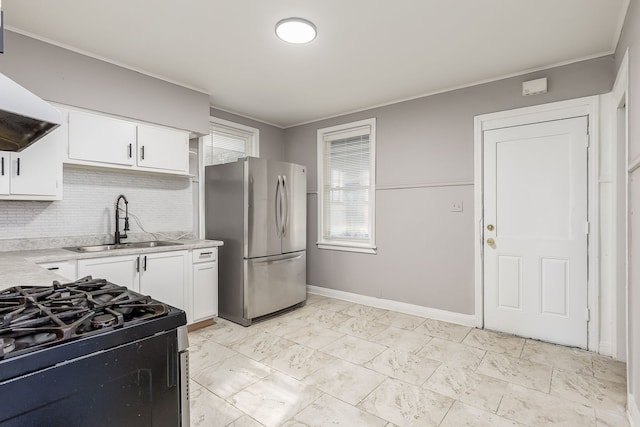 kitchen featuring stainless steel refrigerator, sink, backsplash, extractor fan, and white cabinets