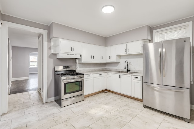 kitchen featuring appliances with stainless steel finishes, backsplash, white cabinetry, and sink