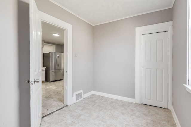 spare room featuring ornamental molding