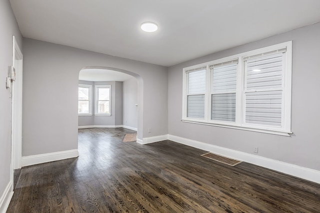 spare room with dark hardwood / wood-style flooring