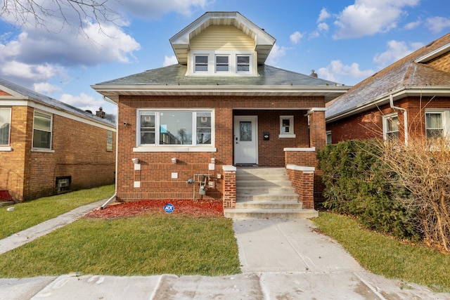 bungalow-style home featuring a front yard