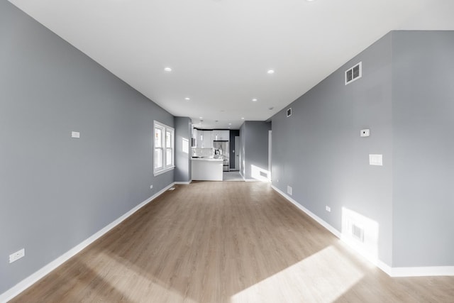 unfurnished living room with light wood-type flooring