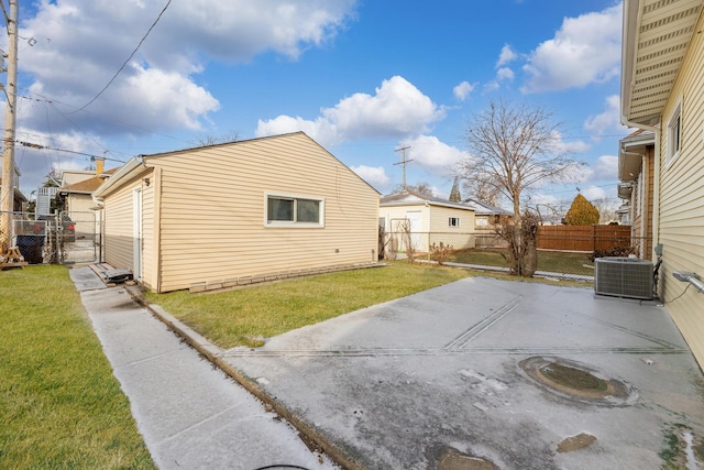 view of side of home with a lawn, a patio area, and cooling unit