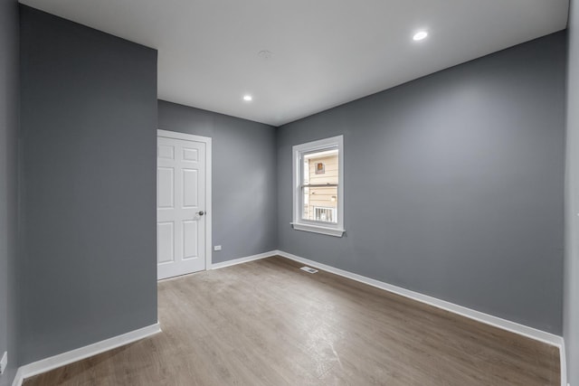 unfurnished room with light wood-type flooring