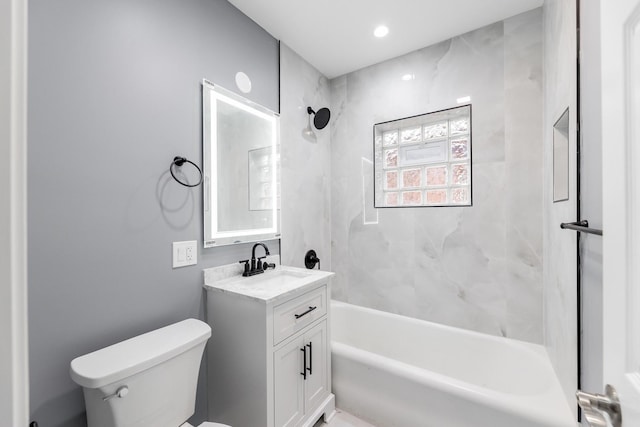 full bathroom with vanity, toilet, and tiled shower / bath combo