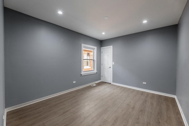 unfurnished room with light hardwood / wood-style flooring