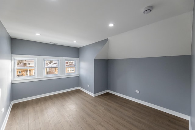 bonus room with hardwood / wood-style floors and lofted ceiling