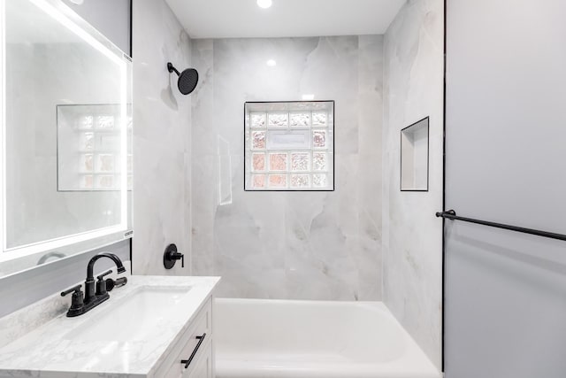 bathroom with vanity and tiled shower / bath combo