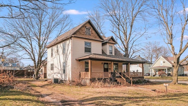 view of front of property with central AC unit, a porch, and a front yard