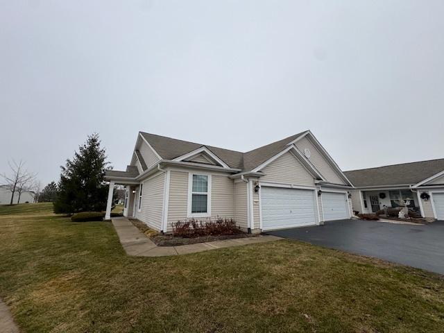 view of front of home with a front lawn and a garage