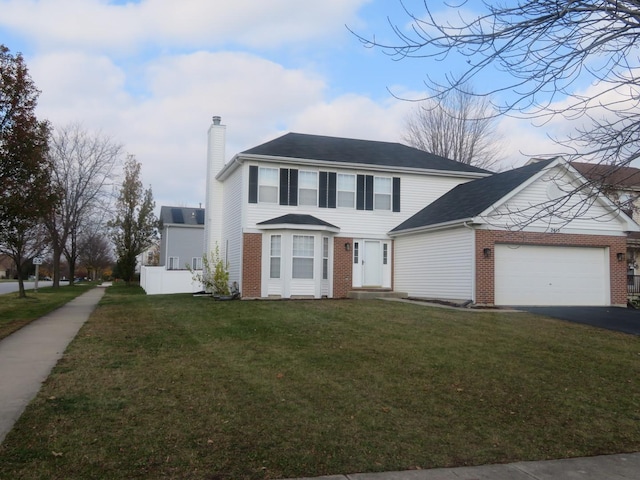 view of front of property with a garage and a front lawn