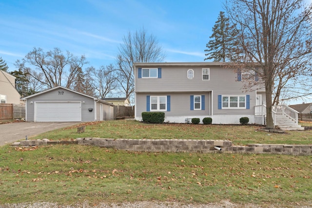 view of front of property with a garage, an outbuilding, and a front lawn