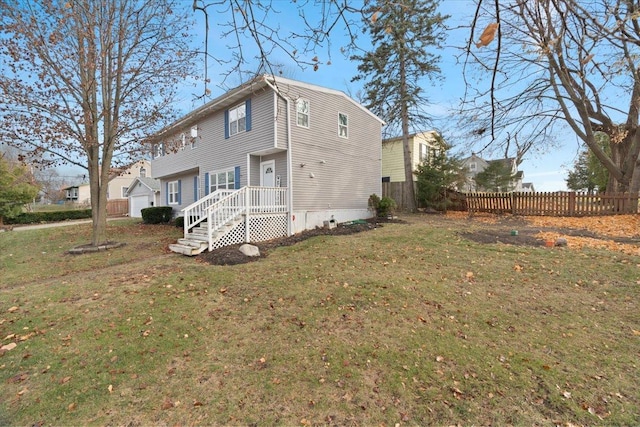 back of house featuring a yard