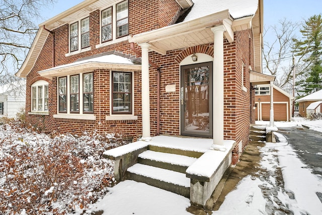 view of snow covered property entrance