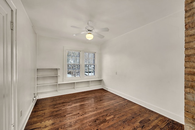 spare room featuring ceiling fan and dark wood-type flooring