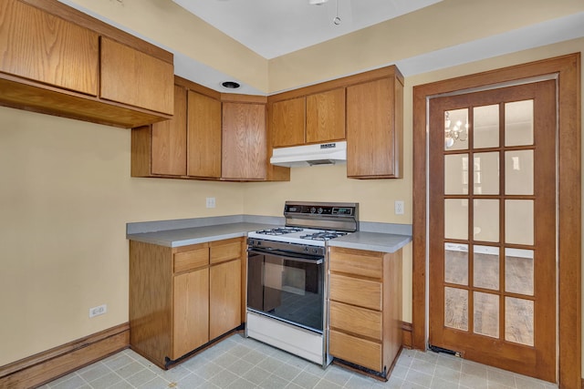 kitchen featuring white stove and an inviting chandelier