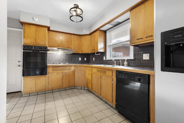 kitchen with tasteful backsplash, tile countertops, sink, and black appliances