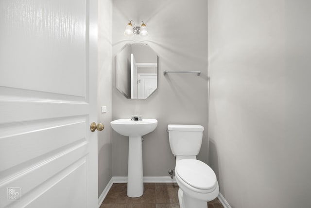 bathroom with tile patterned floors, toilet, and sink