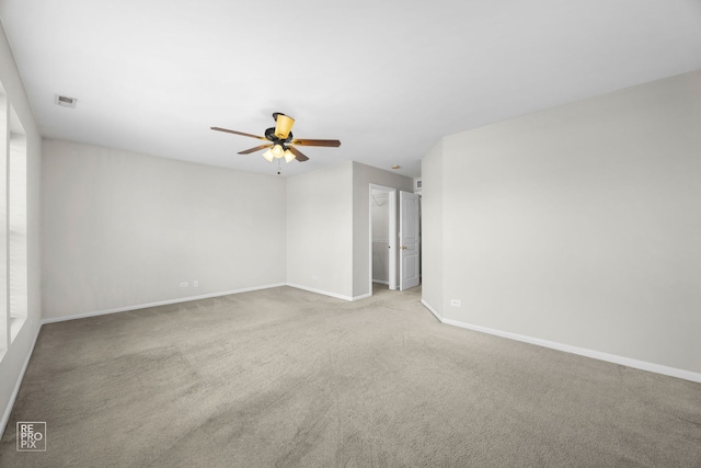 carpeted spare room with ceiling fan