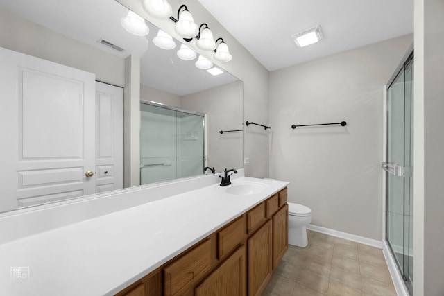 bathroom featuring tile patterned floors, vanity, toilet, and an enclosed shower