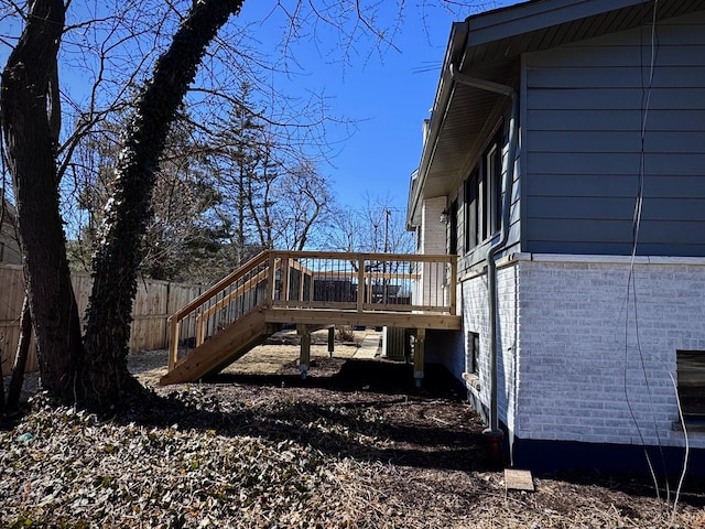 wooden terrace featuring stairway and fence