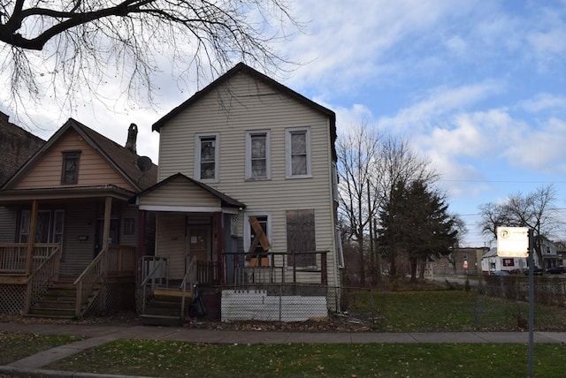 view of front of home with a porch and a front yard