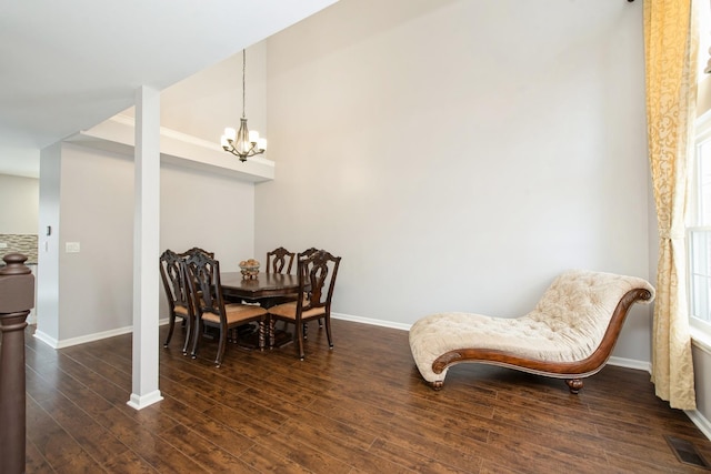 sitting room with dark wood-type flooring and a chandelier