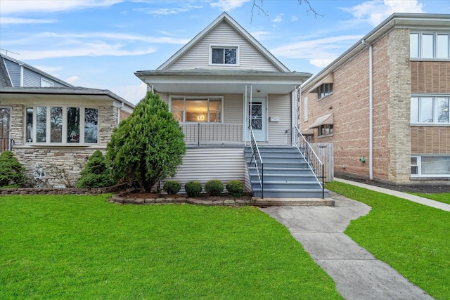 bungalow-style house with a front yard and a porch