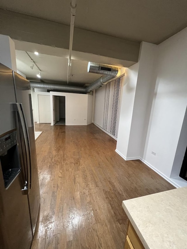 kitchen with stainless steel fridge with ice dispenser, track lighting, and hardwood / wood-style floors