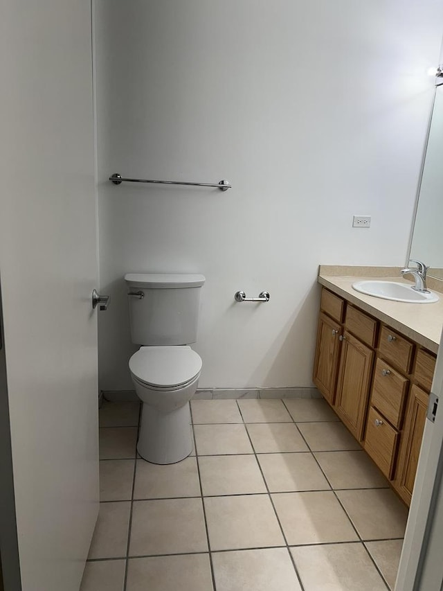 bathroom with tile patterned flooring, vanity, and toilet