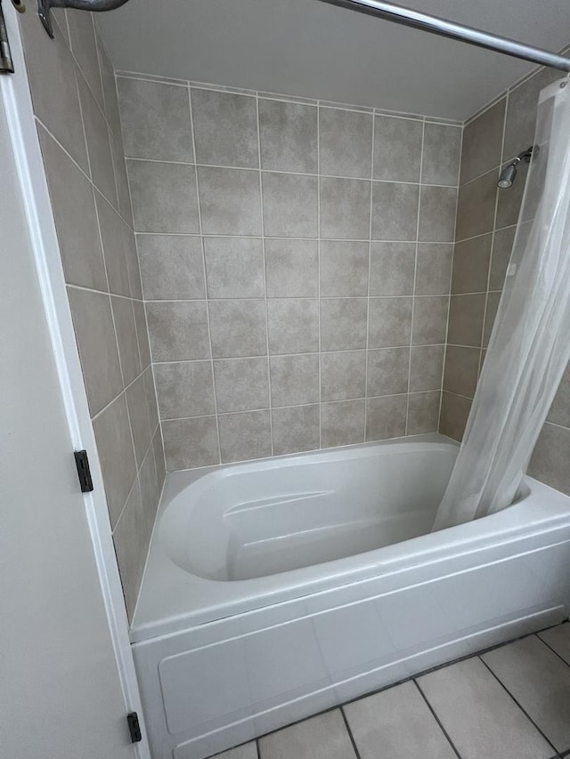 bathroom with tile patterned floors and shower / tub combo