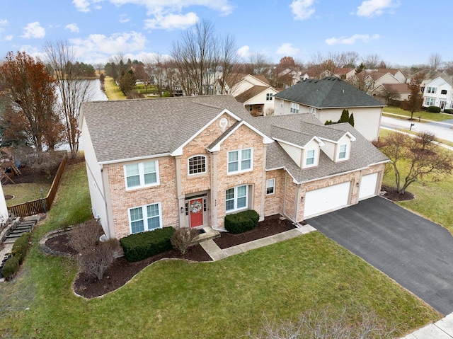 view of front of home with a garage and a front lawn