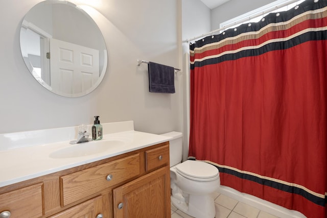 bathroom with tile patterned flooring, vanity, toilet, and walk in shower