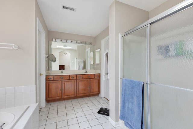 bathroom with shower with separate bathtub, vanity, and tile patterned floors