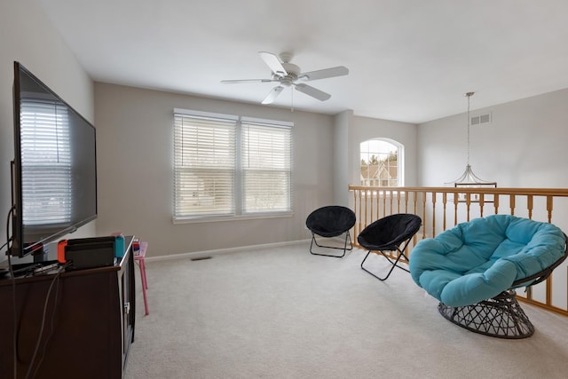 sitting room featuring ceiling fan and light carpet