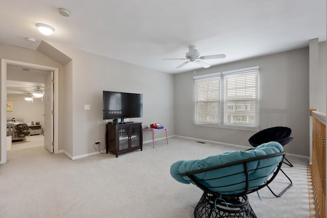 living area featuring ceiling fan and light colored carpet