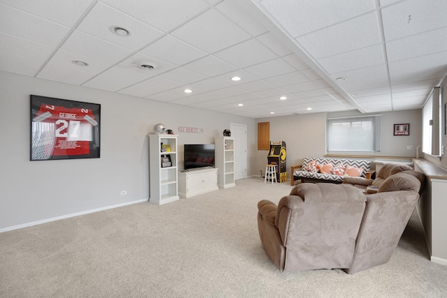 living room with carpet and a paneled ceiling