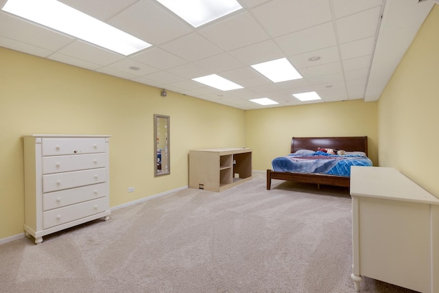 bedroom featuring carpet and a paneled ceiling