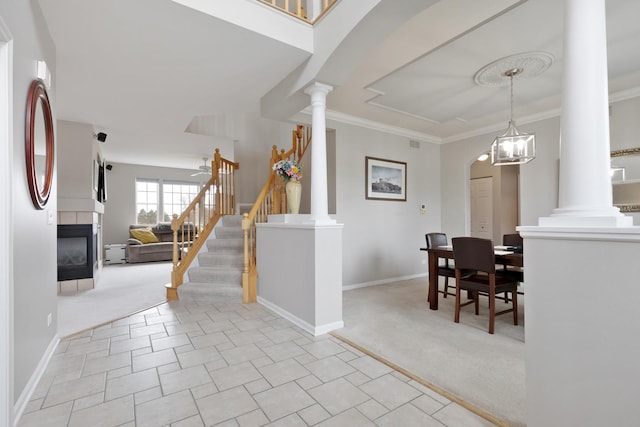 interior space featuring a multi sided fireplace, ornamental molding, and an inviting chandelier