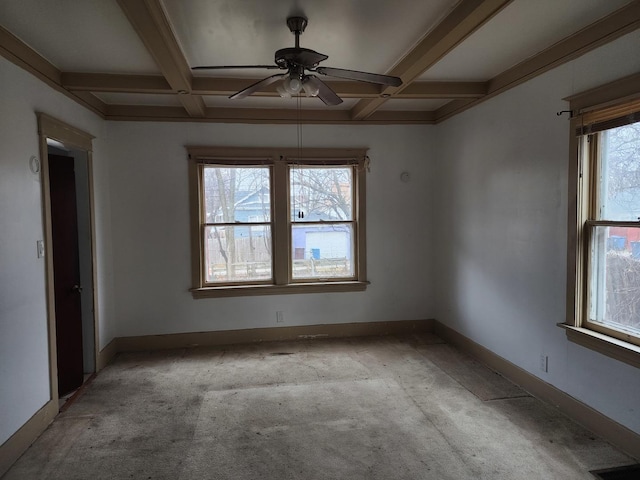 spare room featuring light carpet, beam ceiling, and a wealth of natural light