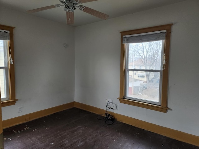 empty room featuring ceiling fan and dark hardwood / wood-style floors