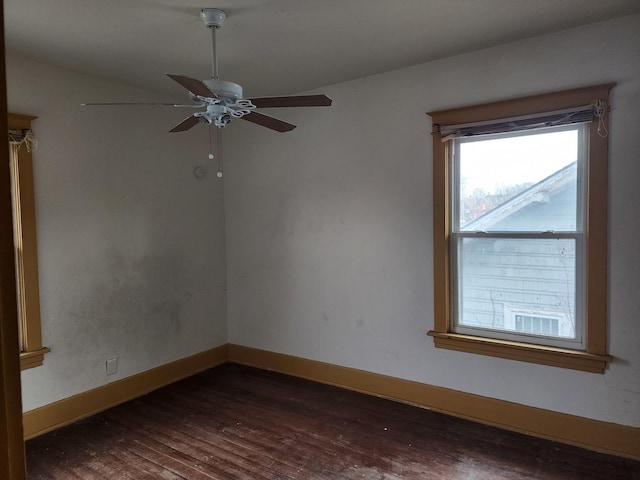 empty room featuring ceiling fan and dark hardwood / wood-style flooring